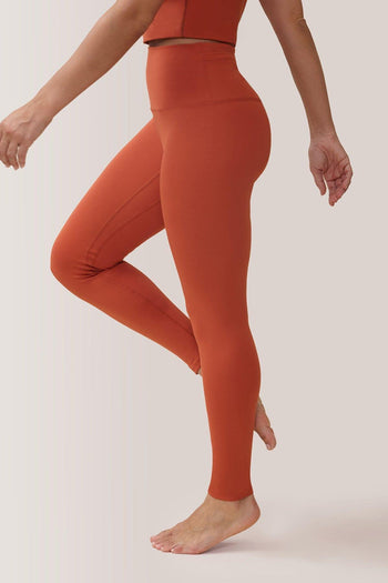 Femme qui porte les leggings mi-haute Magic Sculpting de Rose Boreal./ Women wearing the Magic Sculpting Mid-Rise Legging by Rose Boreal. -Raw Sienna Over / Terre de sienne Over